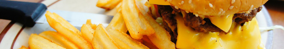 Eating American (Traditional) Burger Hot Dog at Dog Haus restaurant in Burbank, CA.
